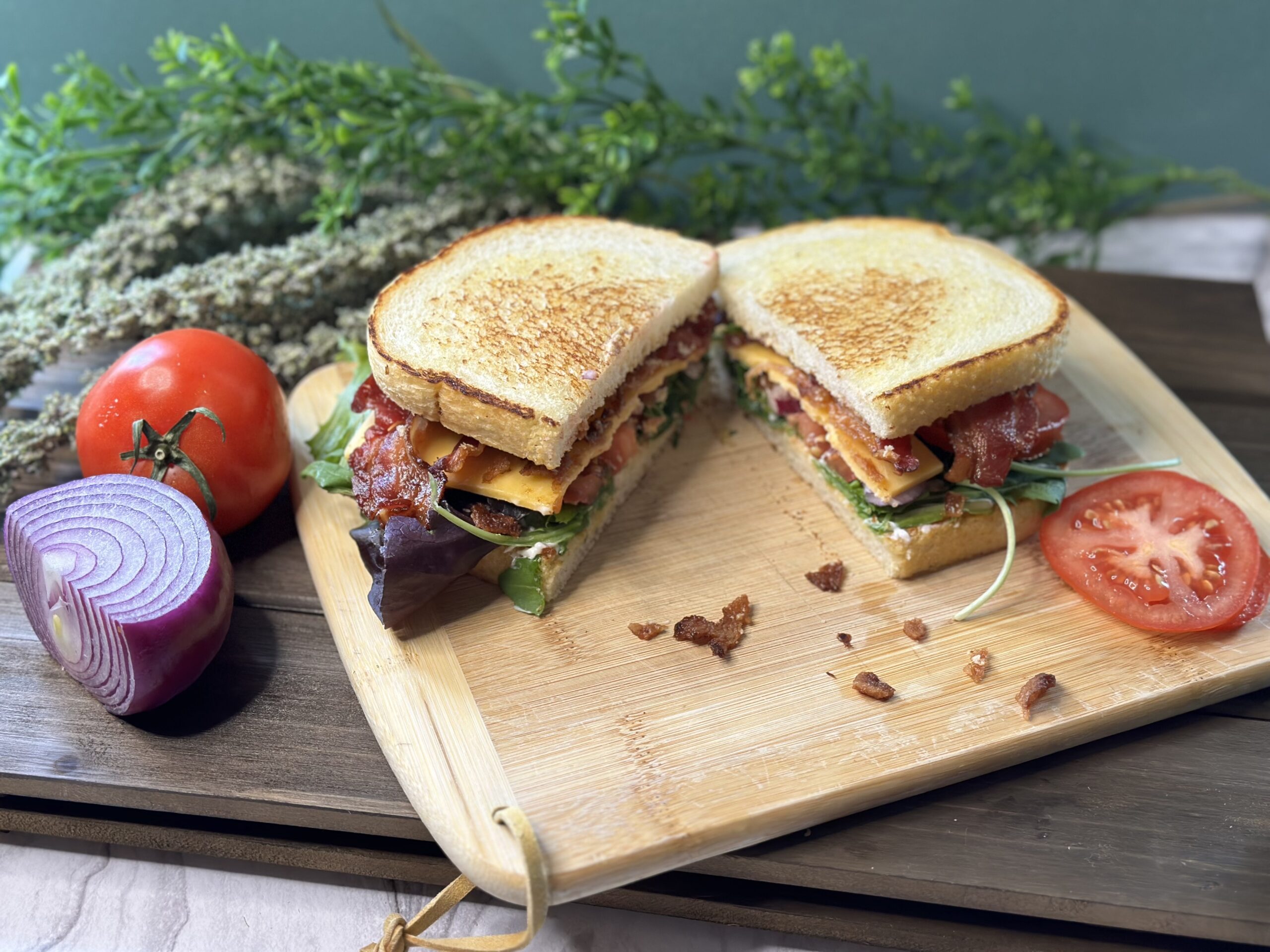 bacon lettuce and tomato sandwich on a cutting board